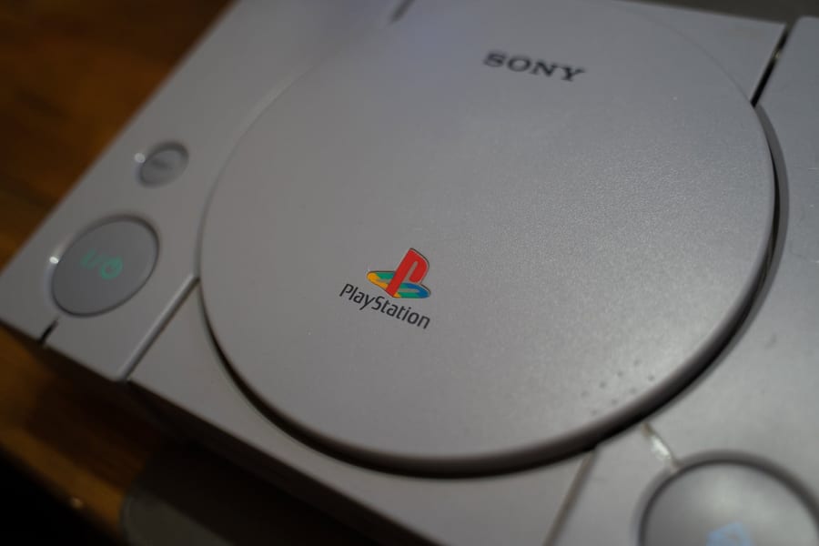 An original Sony PlayStation console on a workbench.