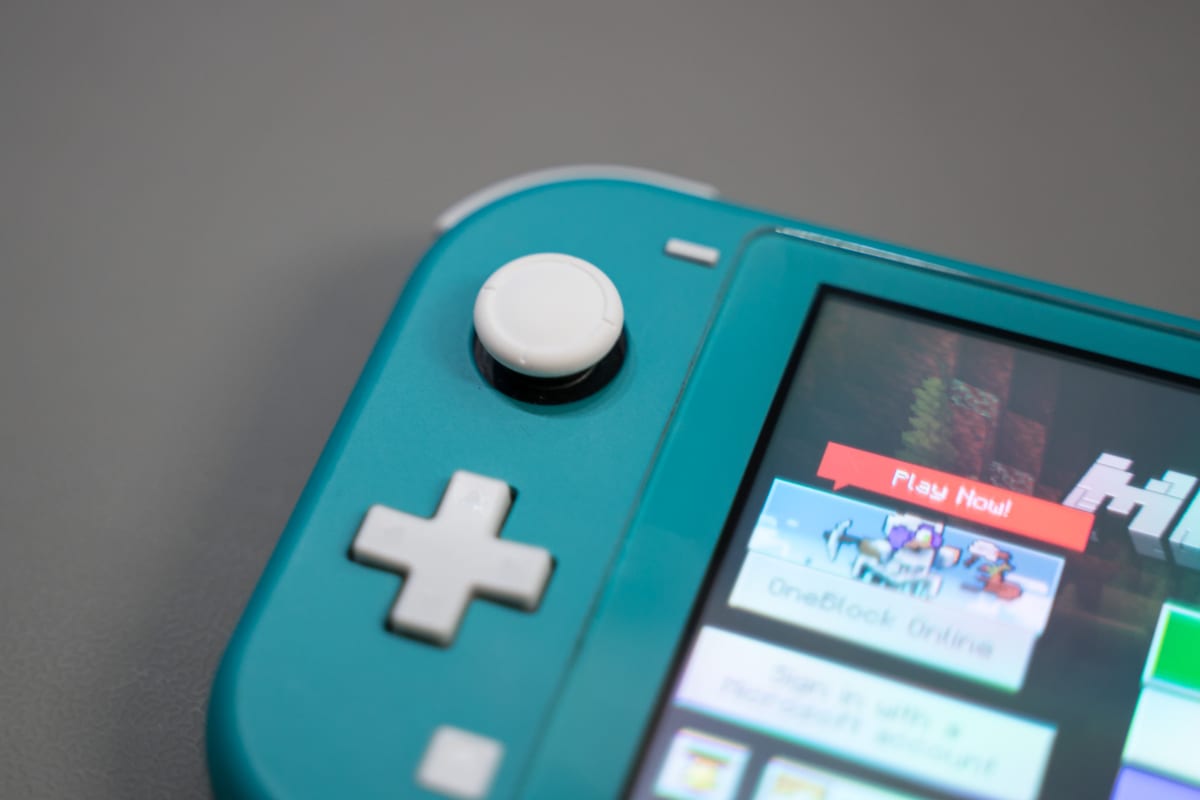 The finished Switch Lite back together, cleaned up and powered on running a game.